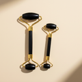 Black obsidian gold jade roller both sizes clean cream background