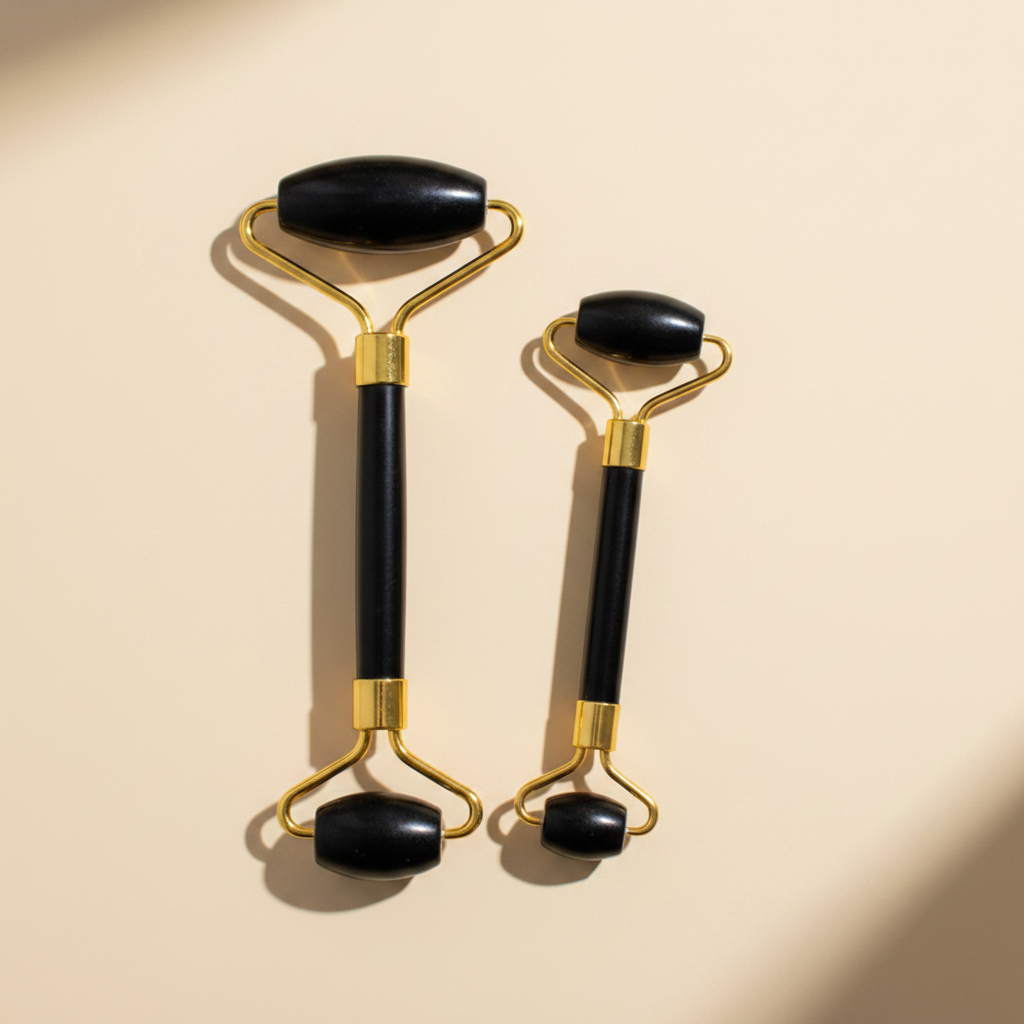 Black obsidian gold jade roller both sizes clean cream background