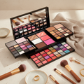 All-in-one makeup palette flat lay cream stone beige towels brushes gold accents