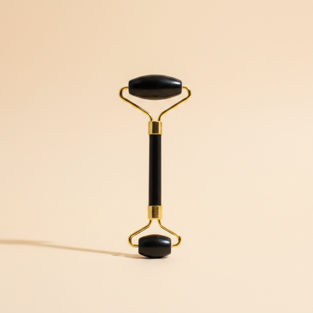 Black obsidian gold jade roller solo cream background